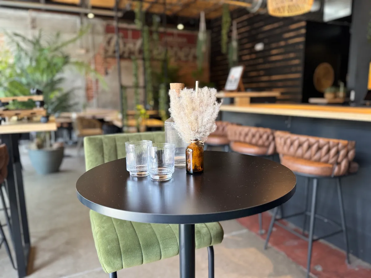 Cocktail table and bar inside Mystic Lounge in Denver