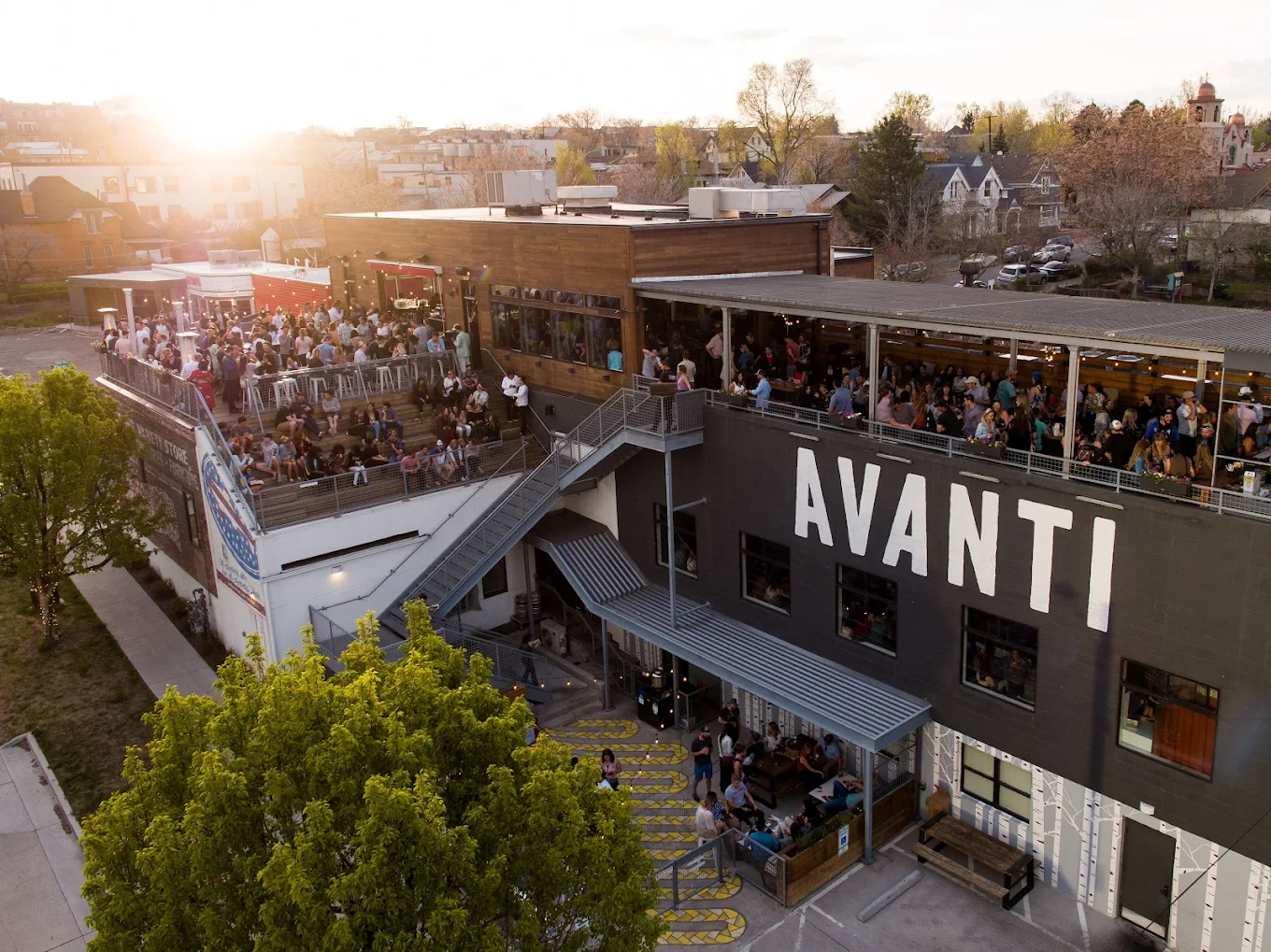 Avanti F&B in LoHi at golden hour — rooftop crowd and bar signage